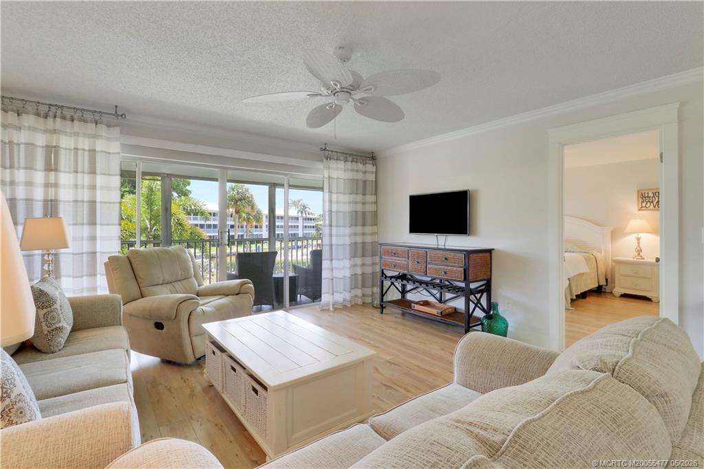 1852 Southwest Palm City Road, Unit 201 Stuart, FL 34994 - Photo 3 of 34 a living room with furniture and a flat screen tv