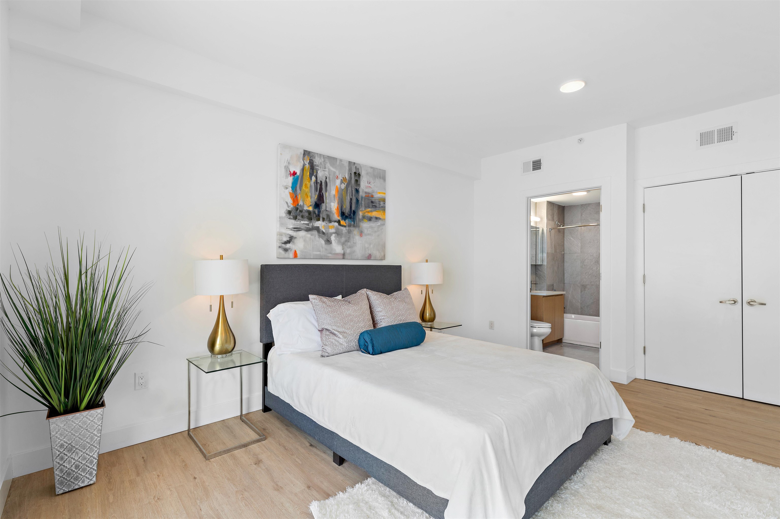 231 Hackensack Plank Road, Unit 208 Weehawken, NJ 07086 - Photo 3 of 7 a bedroom with a bed and wooden floor