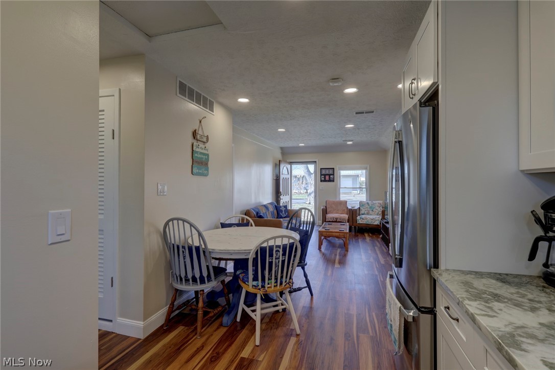 189 Harcourt Road Vermilion, OH 44089 - Photo 12 of 36 Dining room with dark wood-style floors, a textured ceiling, and recessed lighting