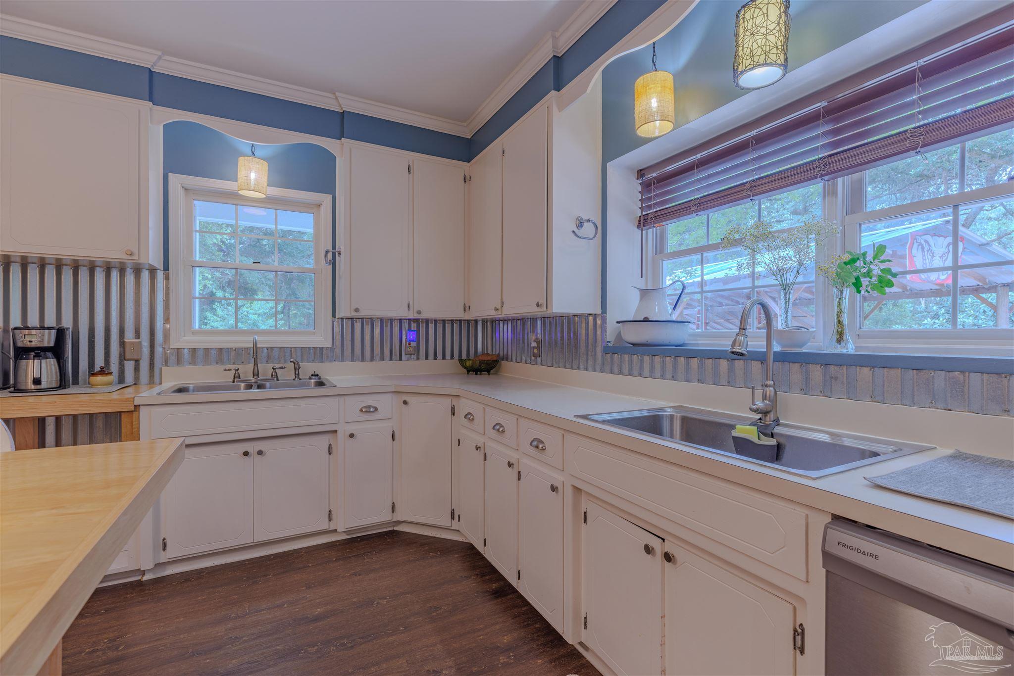 5049 Guernsey Road Pace, FL 32571 - Photo 23 of 61 a kitchen with a sink cabinets and window