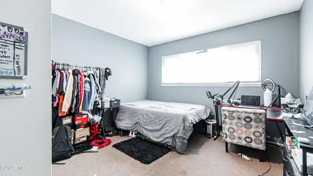 a bed room with a bed and a window