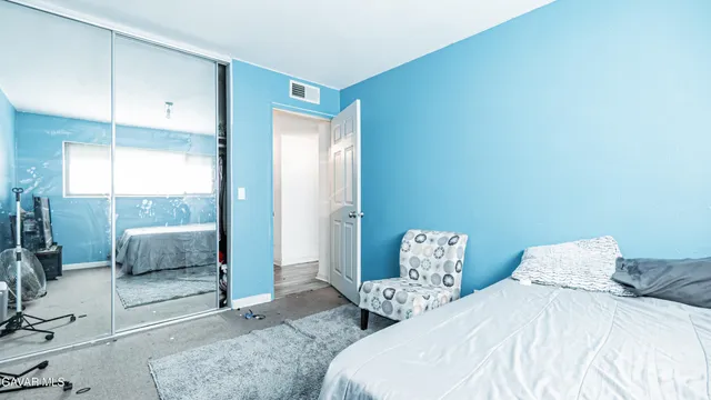 a bedroom with a bed and a couch