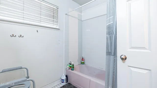 a bathroom with a bathtub and shower