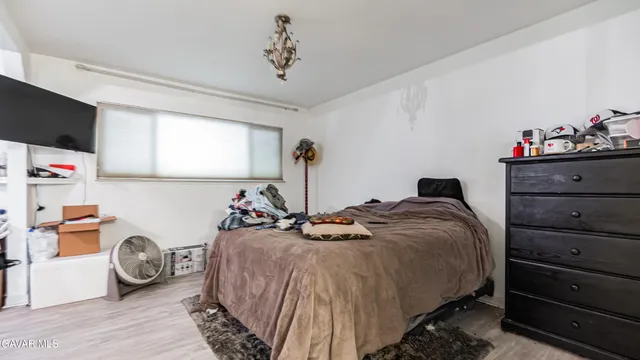 a bed room with a bed and a chair