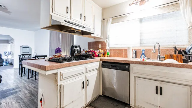 a kitchen with white cabinets and white appliances