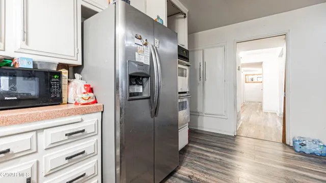 a kitchen with stainless steel appliances a refrigerator and cabinets