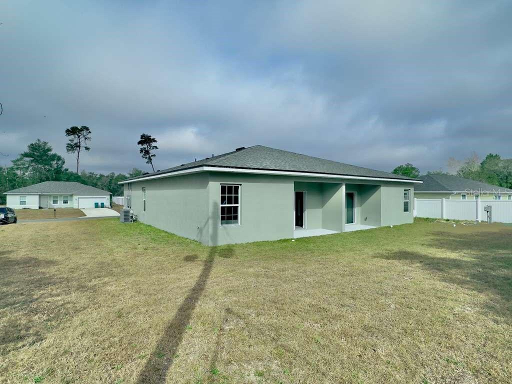 15885 Southwest 35th Court Road, Unit 1 Ocala, FL 34473 - Photo 24 of 27 a view of a house with a backyard