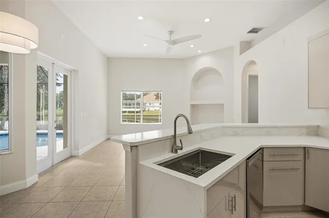 a view of a bedroom with a chandelier fan