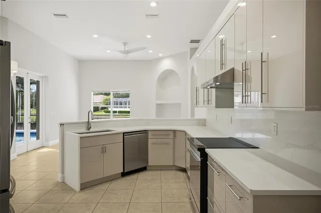 a bathroom with a tub a sink double vanity and mirror