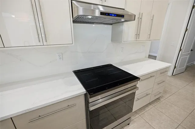 a bathroom with white cabinets and a sink