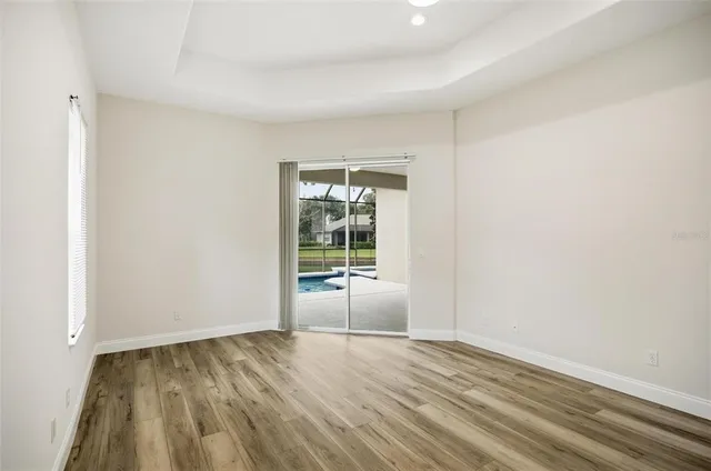 a view of an empty room and wooden floor