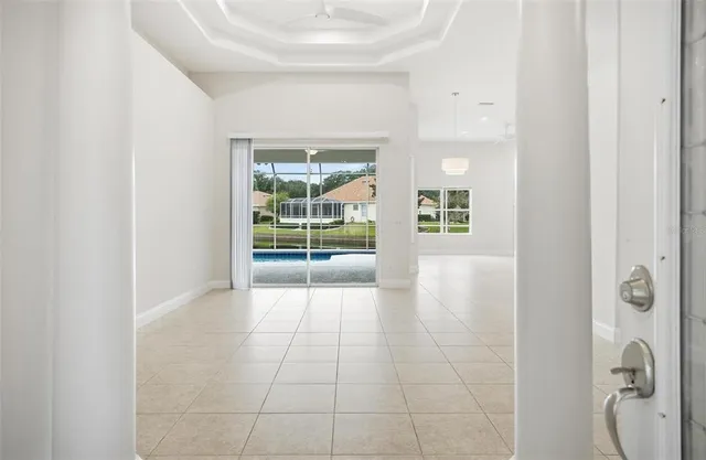 a view of a kitchen with kitchen island stainless steel appliances refrigerator sink and cabinets