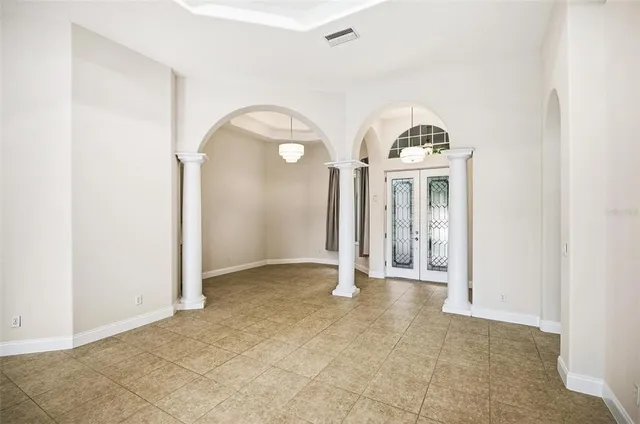 a view of a big room with a large window and refrigerator