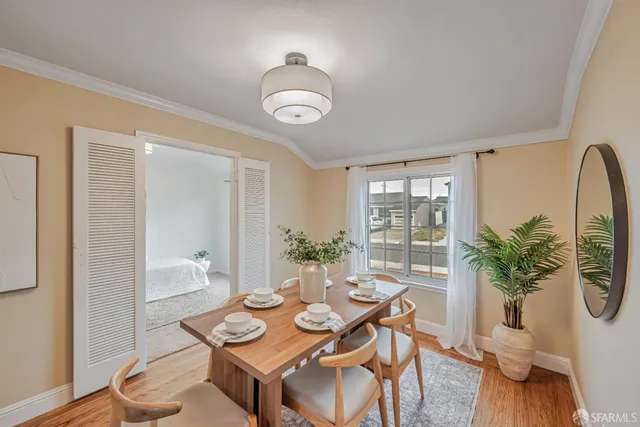 a view of a dining room with furniture and wooden floor