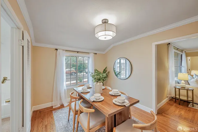 a view of a dining room with furniture window and wooden floor