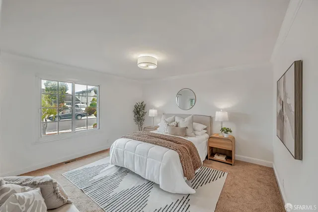 a bedroom with a bed lamp closet and window