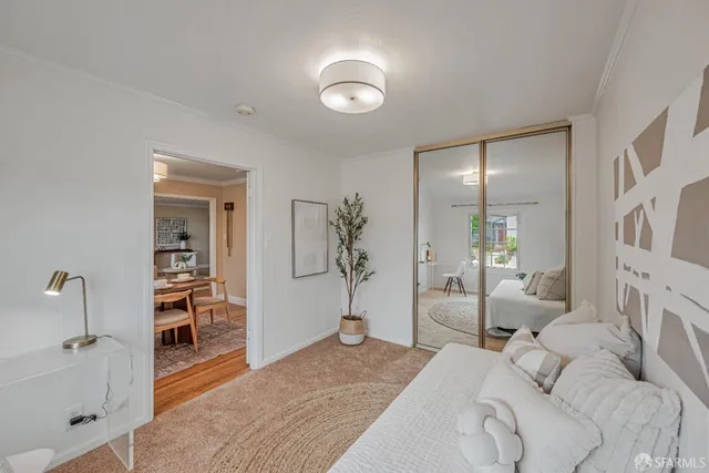 a bedroom with a bed and a large mirror