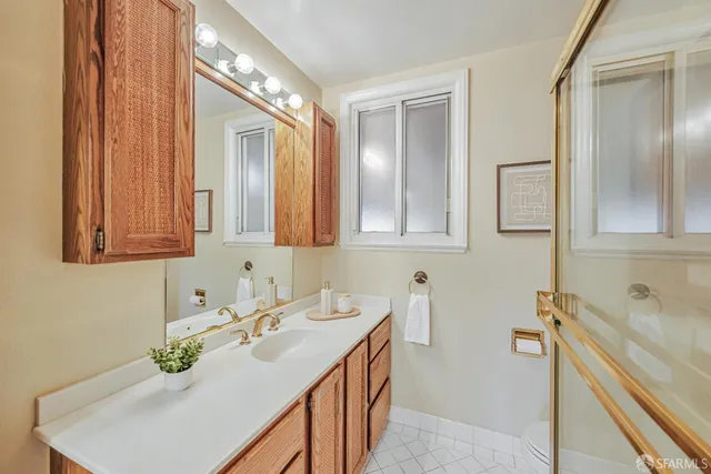 a bathroom with a granite countertop sink and a mirror