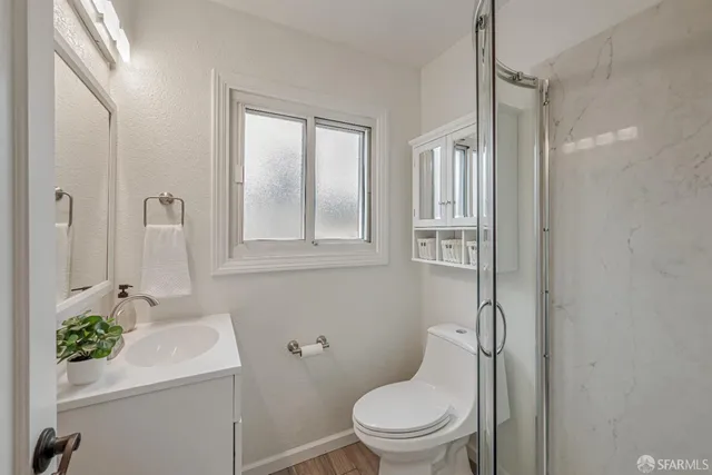 a bathroom with a sink toilet and shower