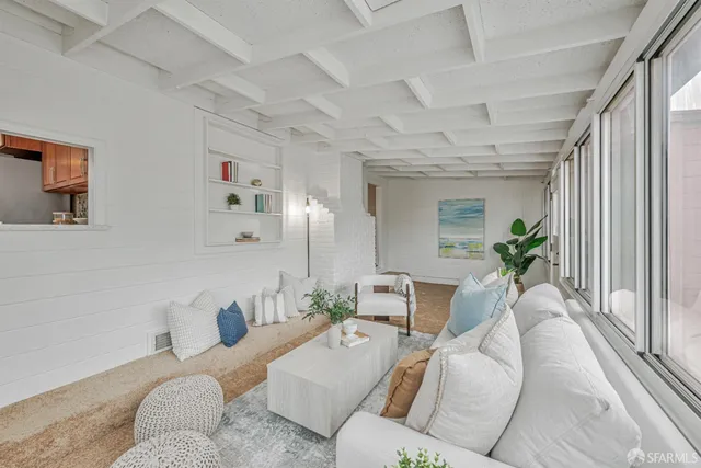 a living room with furniture and a potted plant