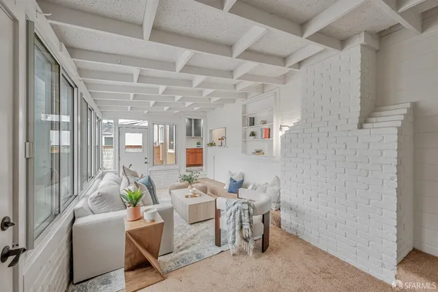 a room with furniture a rug and a window