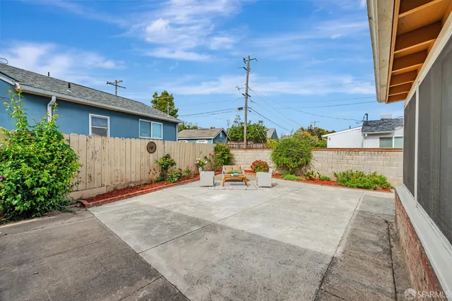 a backyard of a house with outdoor seating