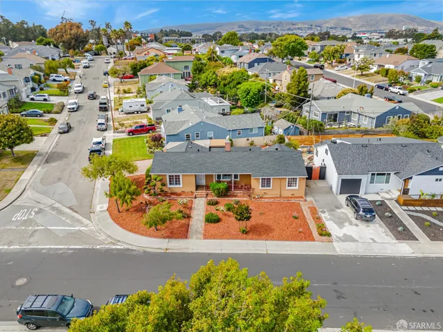 an aerial view of a house with a swimming pool