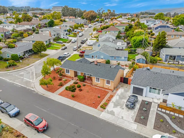 an aerial view of residential houses with outdoor space
