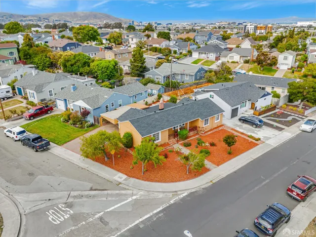 an aerial view of a house with a ocean view
