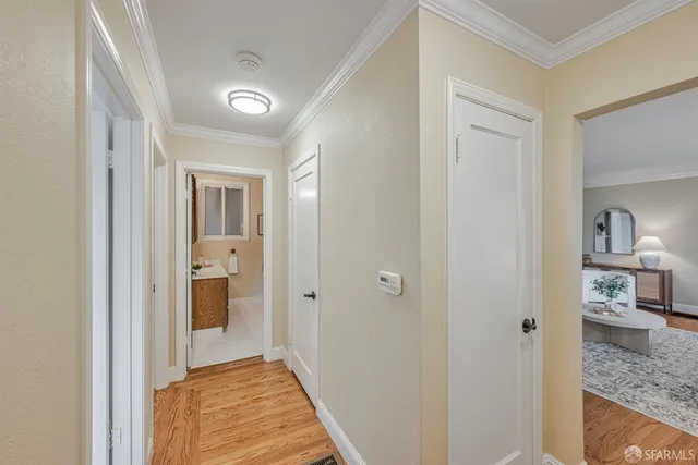 a view of a hallway with a livingroom and a bathroom