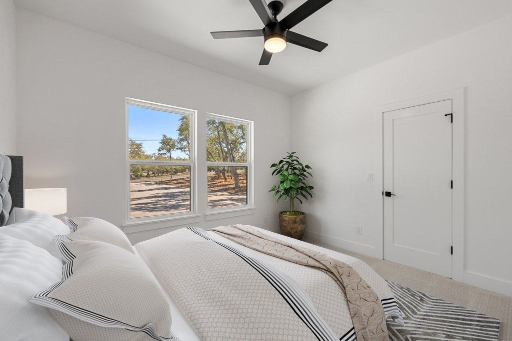 408 Rust Ranch Road Blanco, TX 78606 - Photo 20 of 35 Bedroom featuring a ceiling fan and carpet floors
