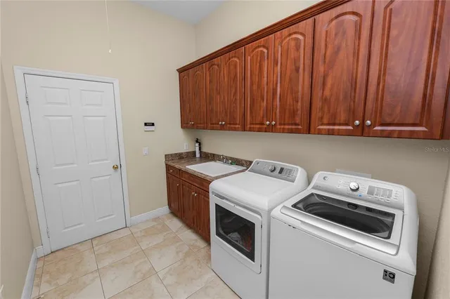 a front view of a house with a garden and trees