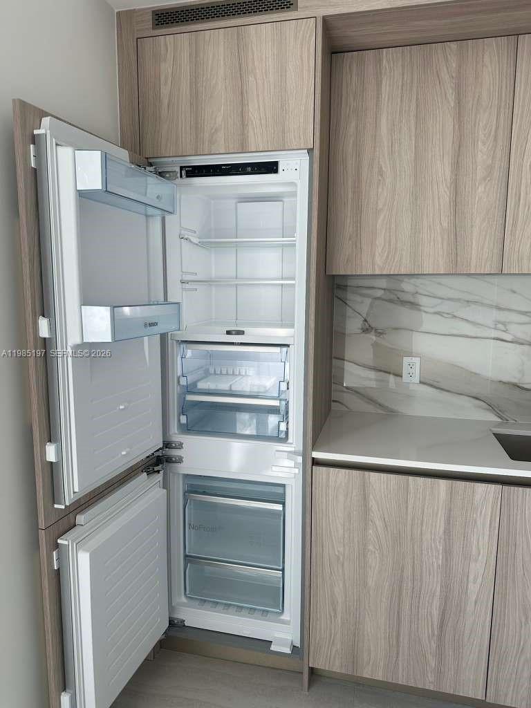 77 Southeast 5th Street, Unit 1513 Miami, FL 33131 - Photo 13 of 49 a close view of walk in closet with empty racks