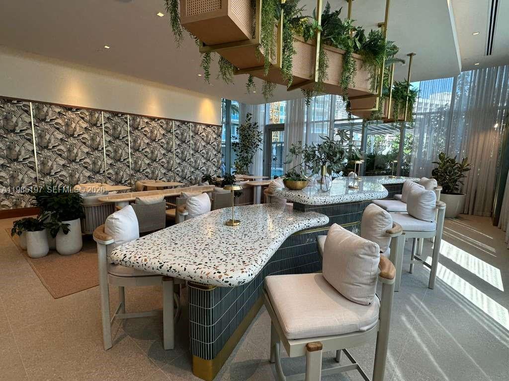 77 Southeast 5th Street, Unit 1513 Miami, FL 33131 - Photo 23 of 49 a outdoor space with lots of table and chairs