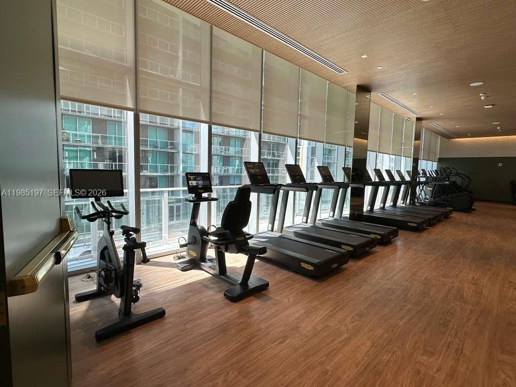 77 Southeast 5th Street, Unit 1513 Miami, FL 33131 - Photo 39 of 49 a view of a room with gym equipment