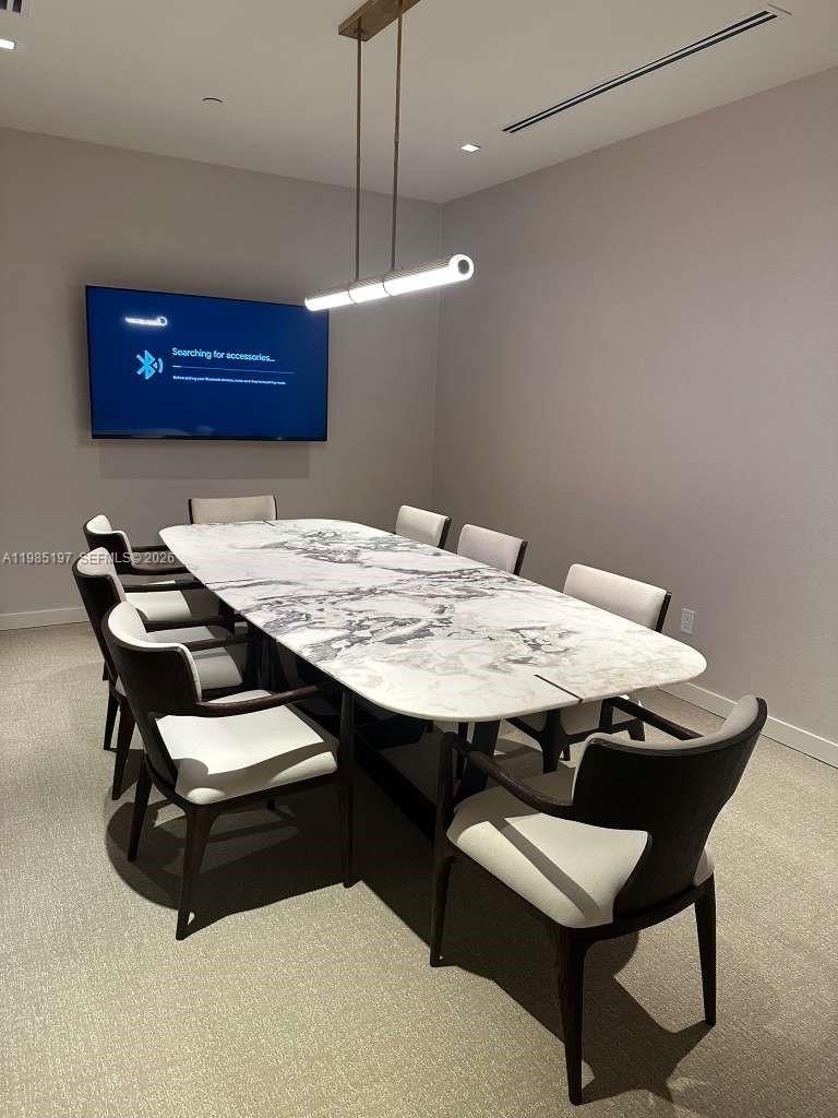 77 Southeast 5th Street, Unit 1513 Miami, FL 33131 - Photo 42 of 49 a view of a tables and chairs in a room