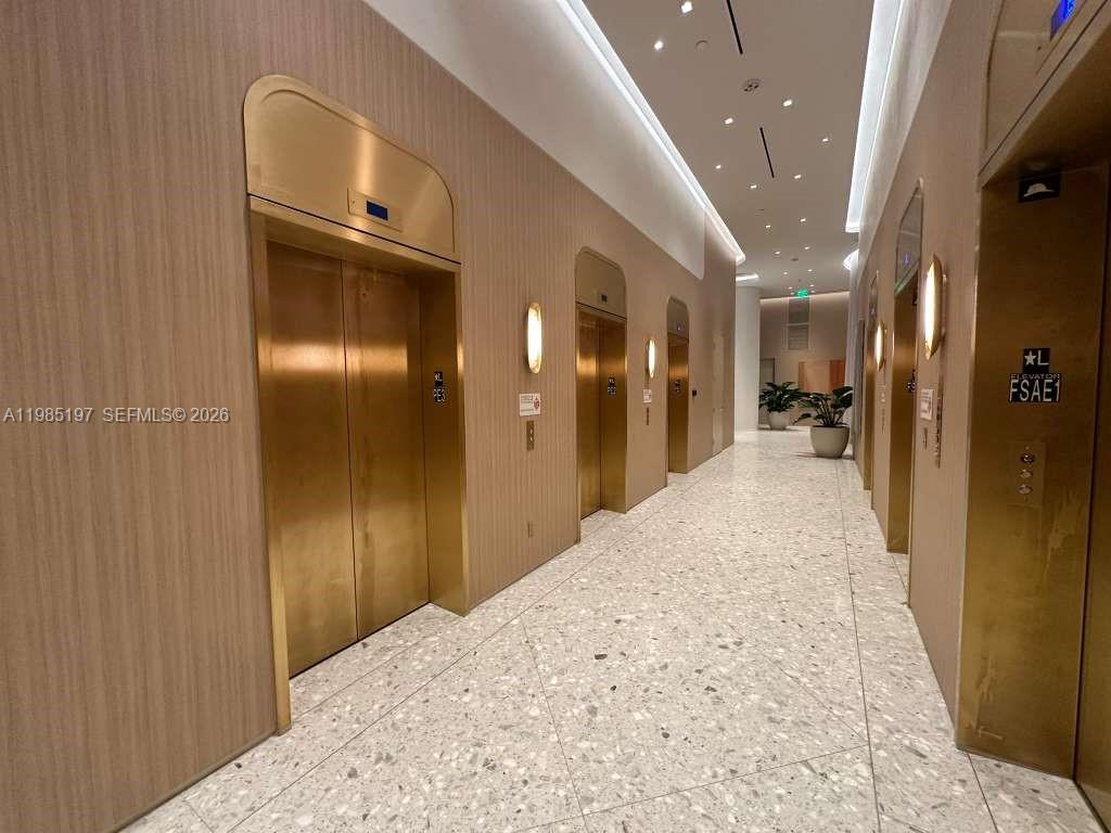 77 Southeast 5th Street, Unit 1513 Miami, FL 33131 - Photo 44 of 49 a view of a hallway with wooden floor