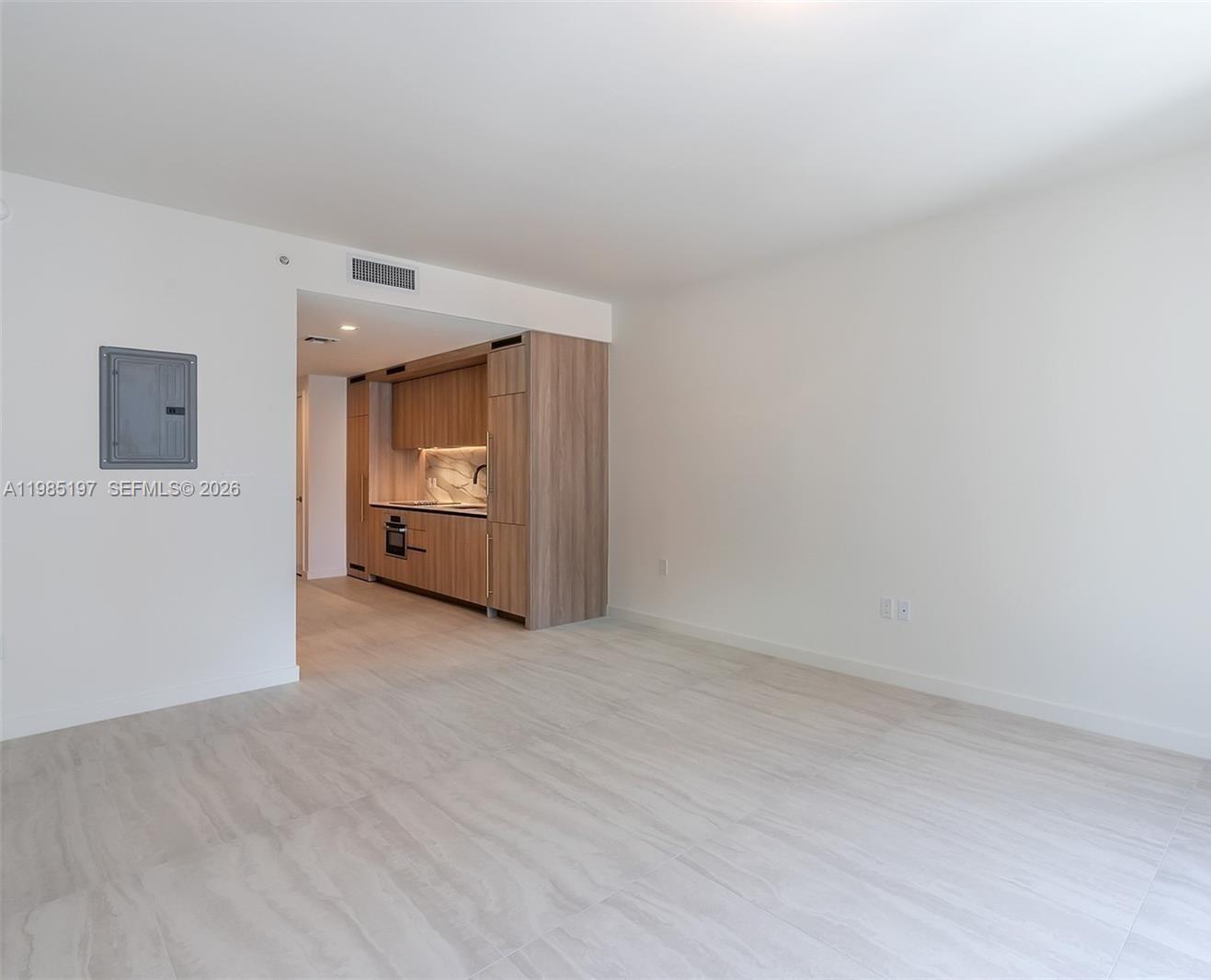77 Southeast 5th Street, Unit 1513 Miami, FL 33131 - Photo 8 of 49 a view of an empty room and a kitchen