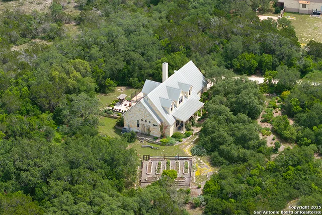an aerial view of a house with a yard basket ball court and outdoor seating