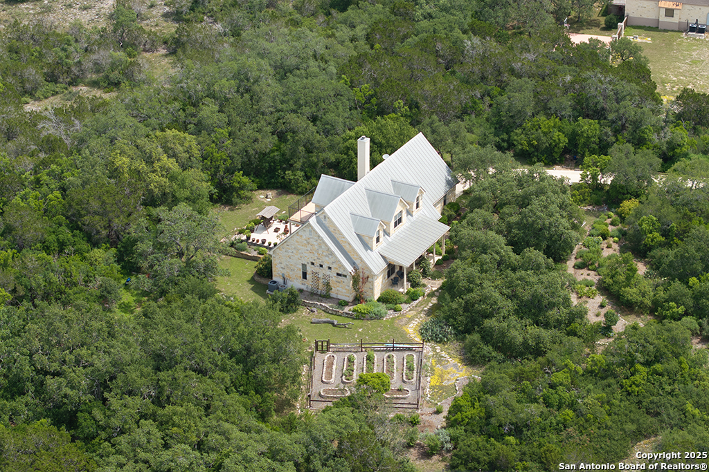 an aerial view of a house with a yard basket ball court and outdoor seating