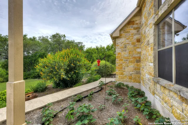 a backyard of a house with table and chairs
