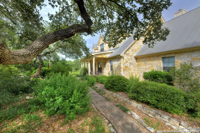 a yellow house with trees in front of it