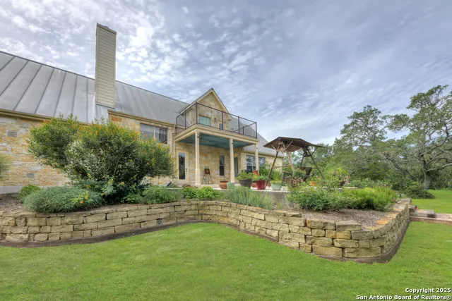 an aerial view of a house with a yard