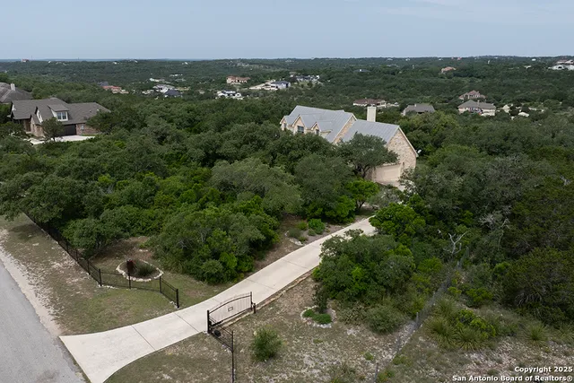 an aerial view of a house with a yard and outdoor seating