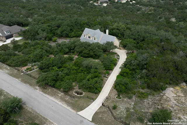 an aerial view of a house with a yard
