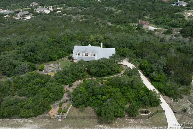 an aerial view of a house with a yard