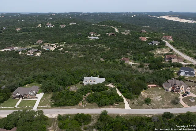 an aerial view of residential houses with outdoor space and river
