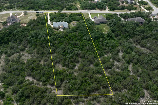 an aerial view of a house with a yard