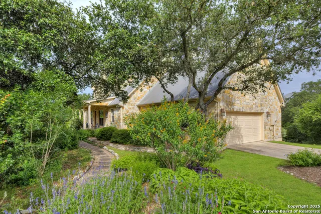 a view of backyard of house with green space