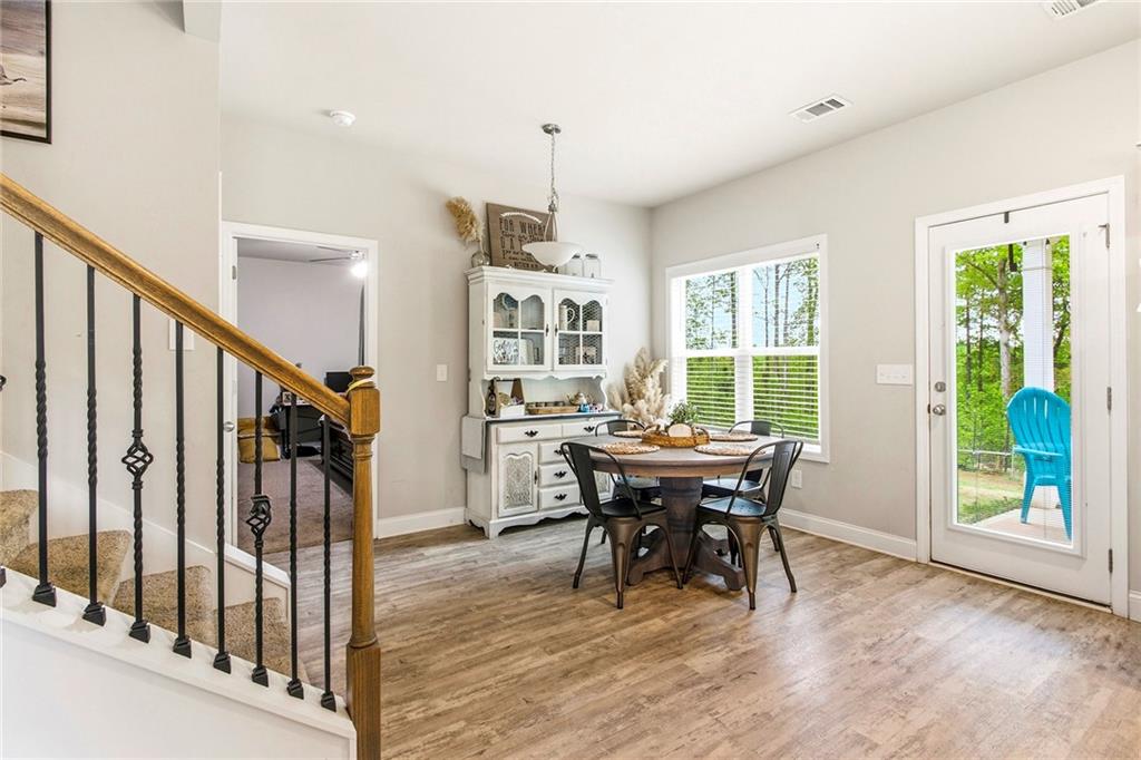 171 Strickland Loop Forsyth, GA 31029 - Photo 10 of 25 a view of a dining room with furniture window and wooden floor